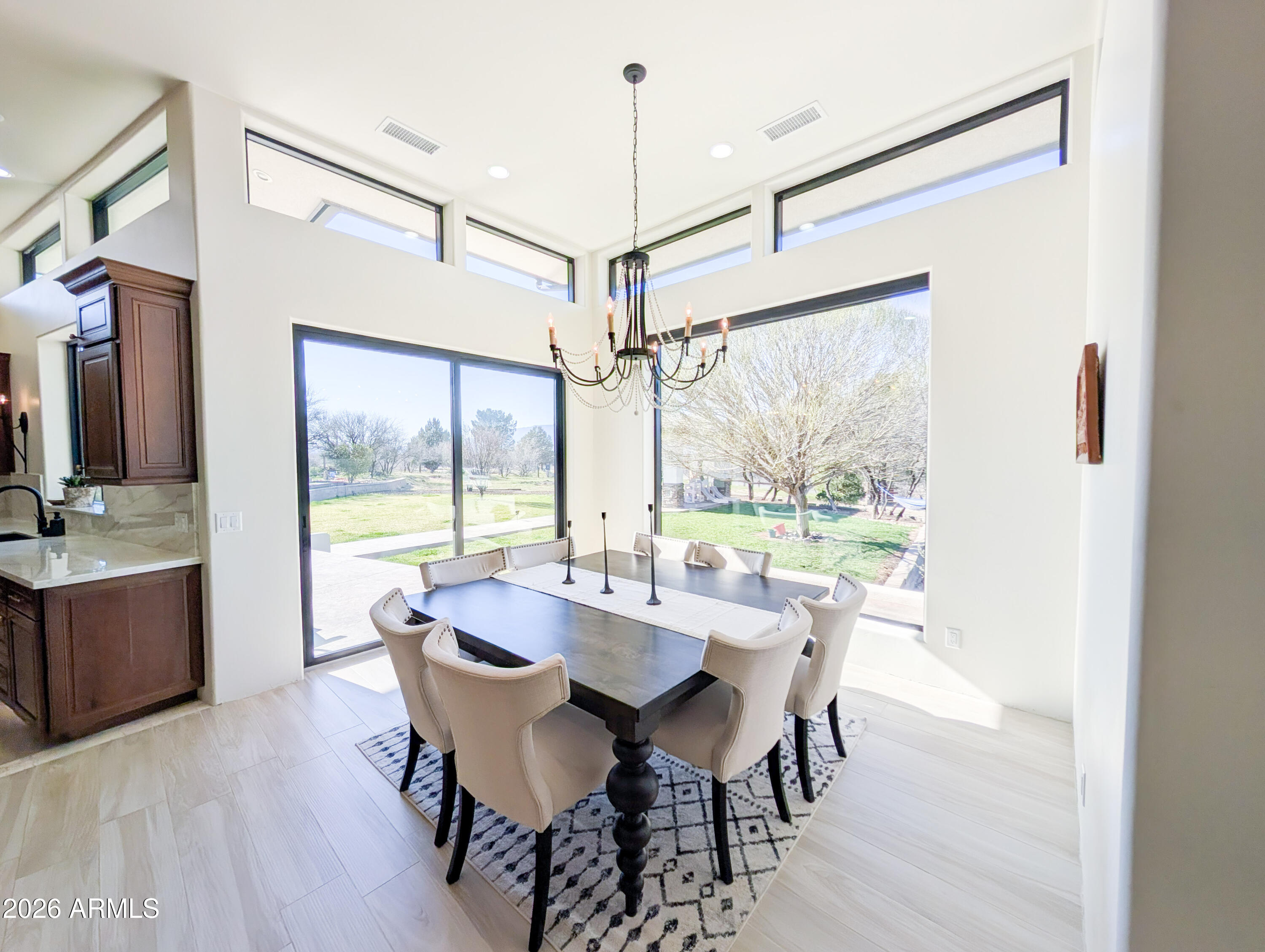 2833 South Old Church Road Camp Verde, AZ 86322 - Photo 37 of 116 a dining room with furniture a chandelier and wooden floor