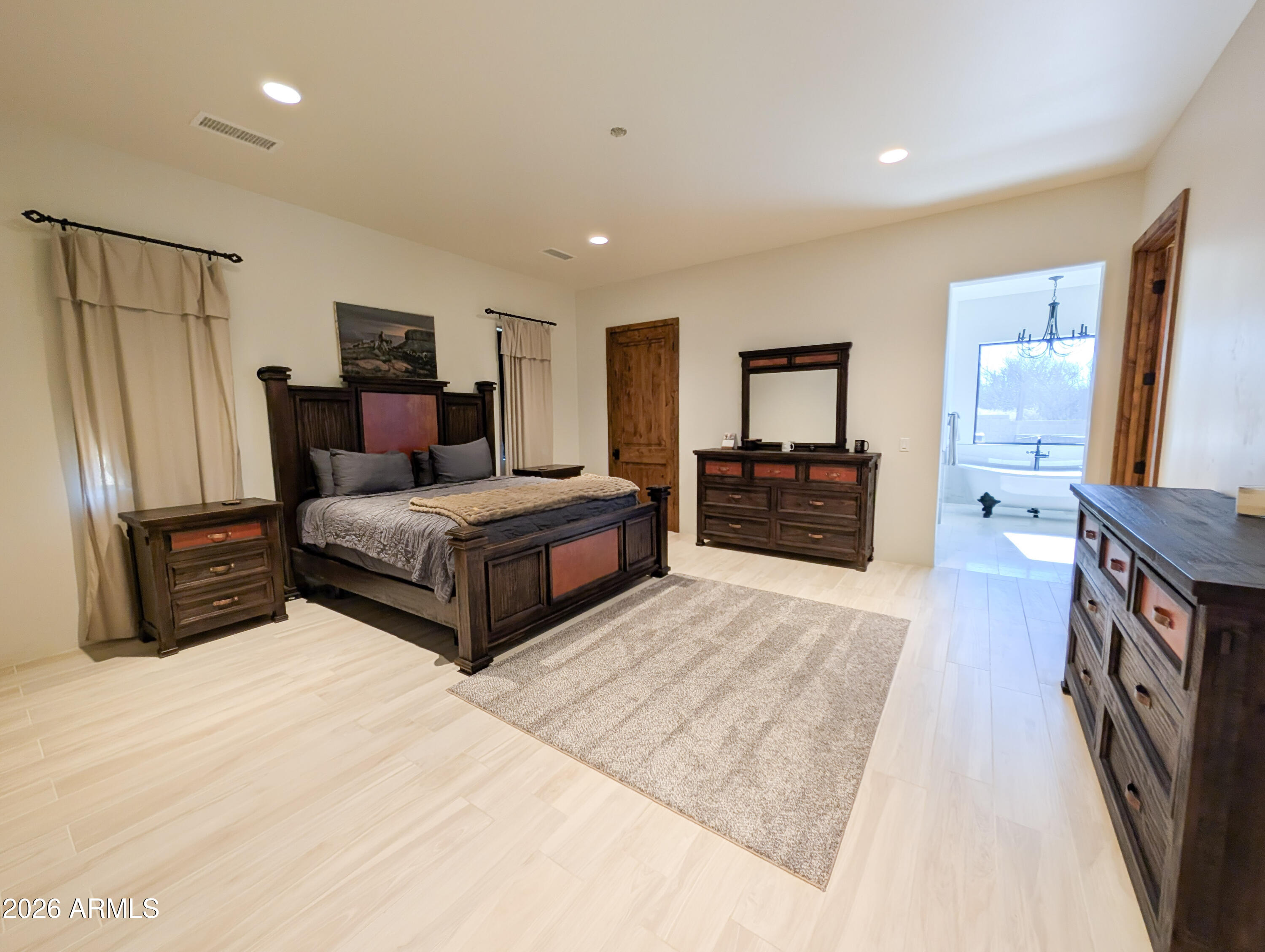 2833 South Old Church Road Camp Verde, AZ 86322 - Photo 65 of 116 a spacious bedroom with a bed and a large mirror