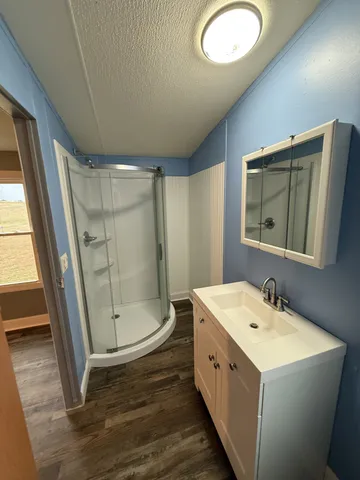 a bathroom with a double vanity sink mirror and shower
