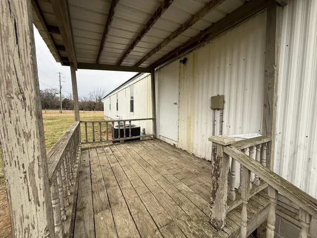 a view of balcony with wooden floor and staircase