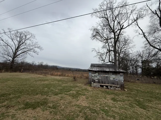 a view of a backyard with wooden fence