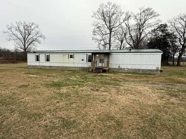 a house that has a tree in front of it