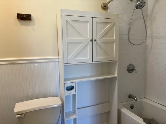 a bathroom with a toilet a sink and shower