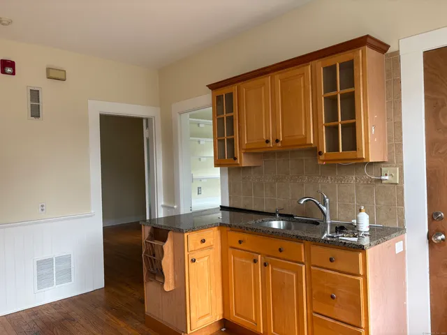 a kitchen with stainless steel appliances granite countertop a sink a stove and cabinets
