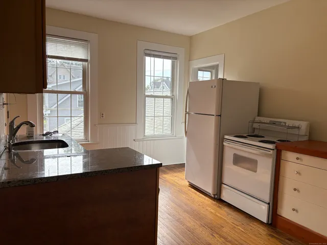 a kitchen with a sink a stove and cabinets