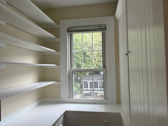 a view of room with window and front door