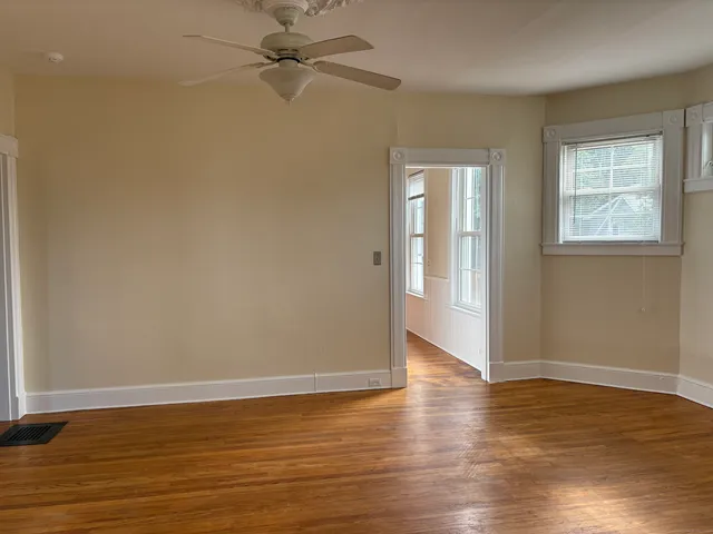 wooden floor in an empty room with a window