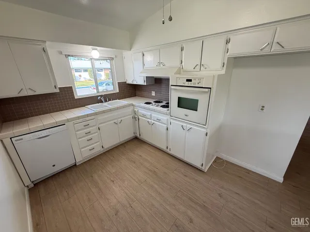 a kitchen with cabinets a sink and appliances