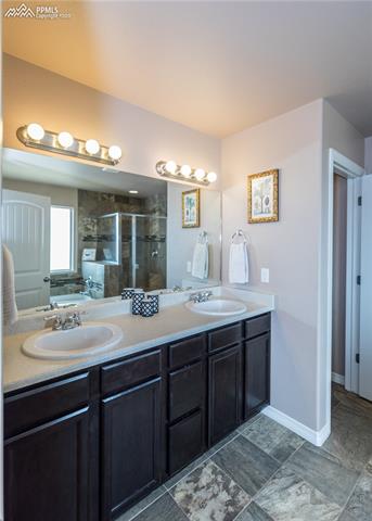2105 Reed Grass Way Colorado Springs, CO 80915 - Photo 13 of 23 Dual counter-height vanity, designer upgrade tile floors, with a privacy door for the water closet.