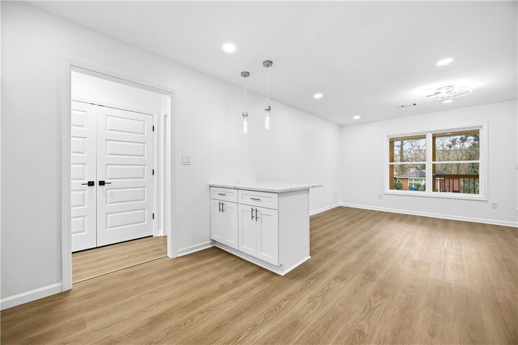 1775 Hadlock Street Southwest Atlanta, GA 30311 - Photo 11 of 27 a view of an empty room with a window and wooden floor