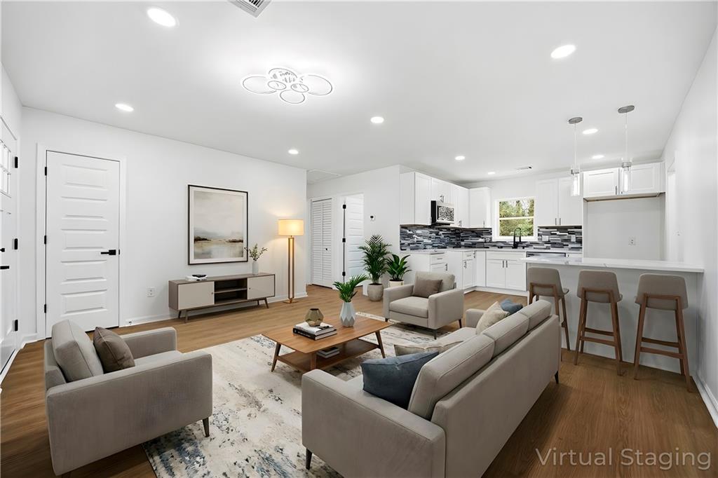 1775 Hadlock Street Southwest Atlanta, GA 30311 - Photo 12 of 27 a living room with furniture and a view of kitchen
