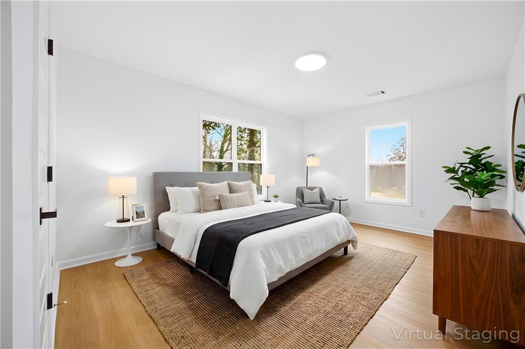 1775 Hadlock Street Southwest Atlanta, GA 30311 - Photo 14 of 27 a bedroom with a bed and a potted plant