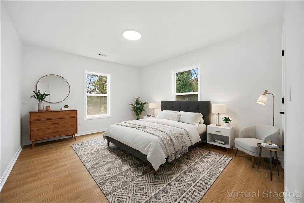 1775 Hadlock Street Southwest Atlanta, GA 30311 - Photo 15 of 27 a bedroom with a bed wooden floor and window
