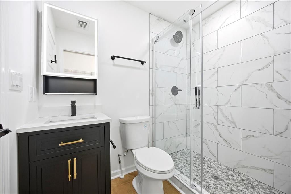 1775 Hadlock Street Southwest Atlanta, GA 30311 - Photo 17 of 27 a bathroom with a sink toilet and shower