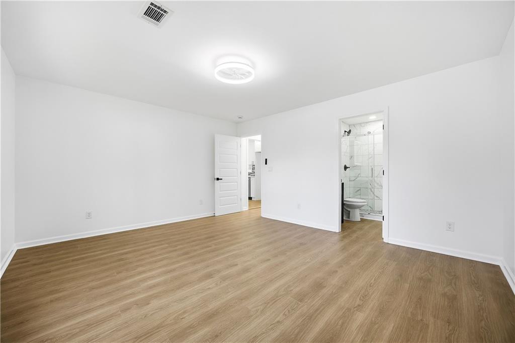 1775 Hadlock Street Southwest Atlanta, GA 30311 - Photo 18 of 27 a view of an empty room with wooden floor