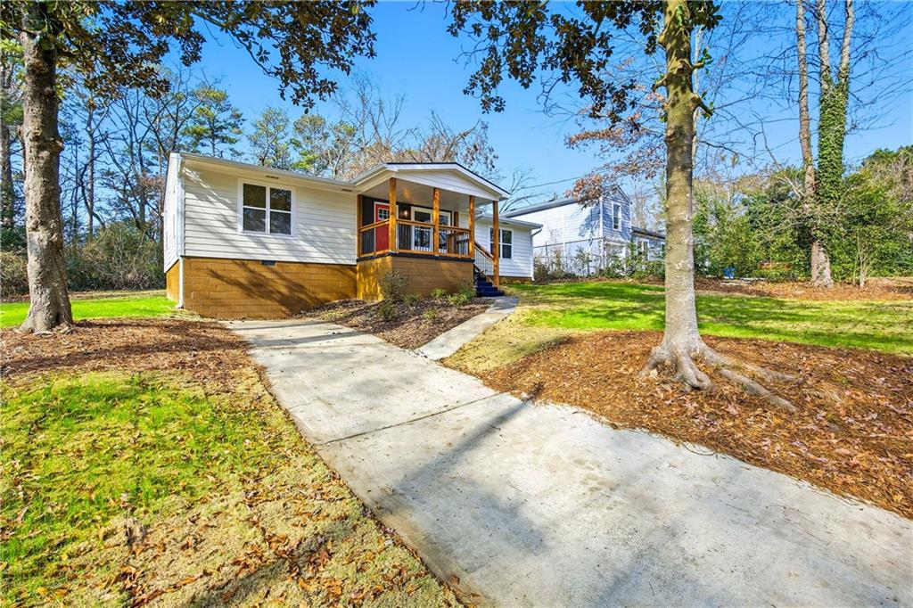 1775 Hadlock Street Southwest Atlanta, GA 30311 - Photo 2 of 27 a front view of a house with a yard