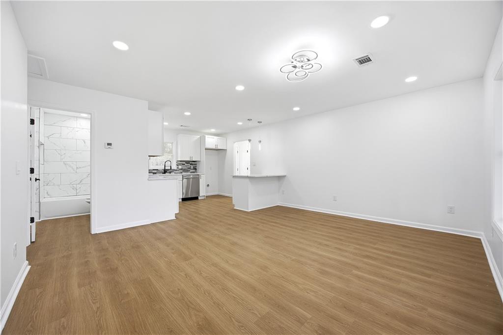 1775 Hadlock Street Southwest Atlanta, GA 30311 - Photo 6 of 27 a view of kitchen and empty room with wooden floor