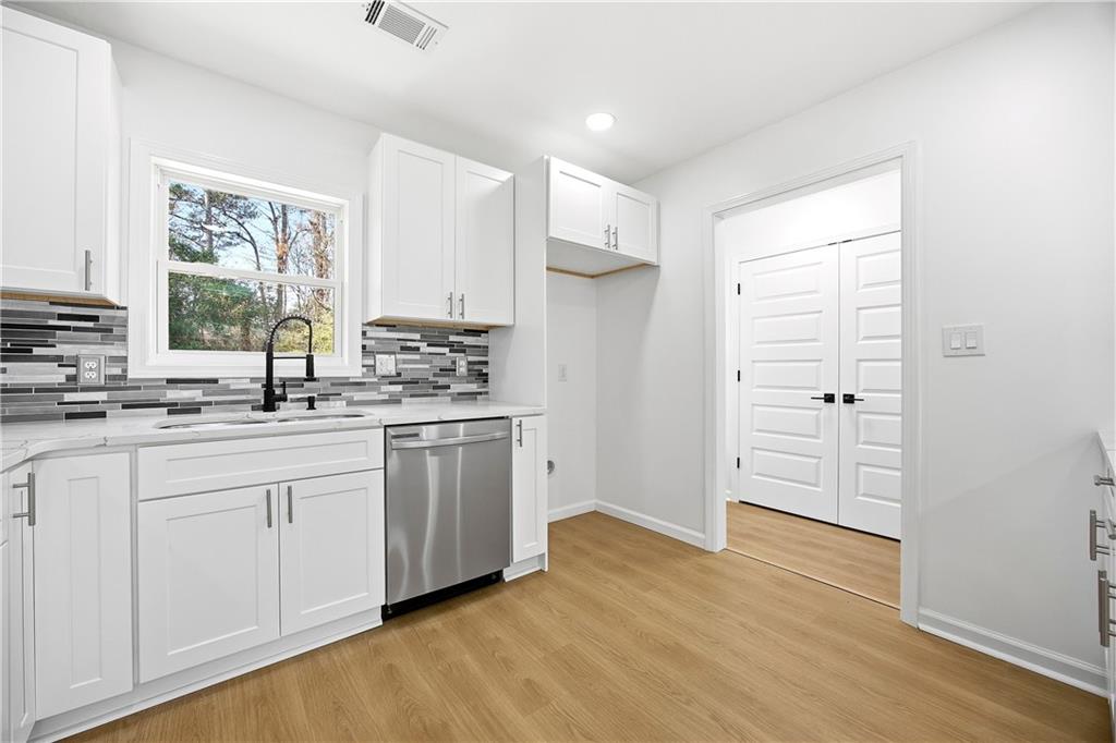 1775 Hadlock Street Southwest Atlanta, GA 30311 - Photo 9 of 27 a kitchen with granite countertop white cabinets and white appliances