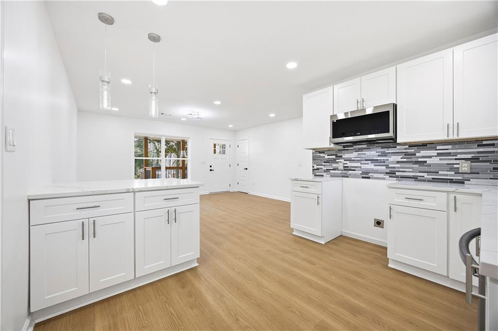 1775 Hadlock Street Southwest Atlanta, GA 30311 - Photo 10 of 27 a kitchen with white cabinets and sink