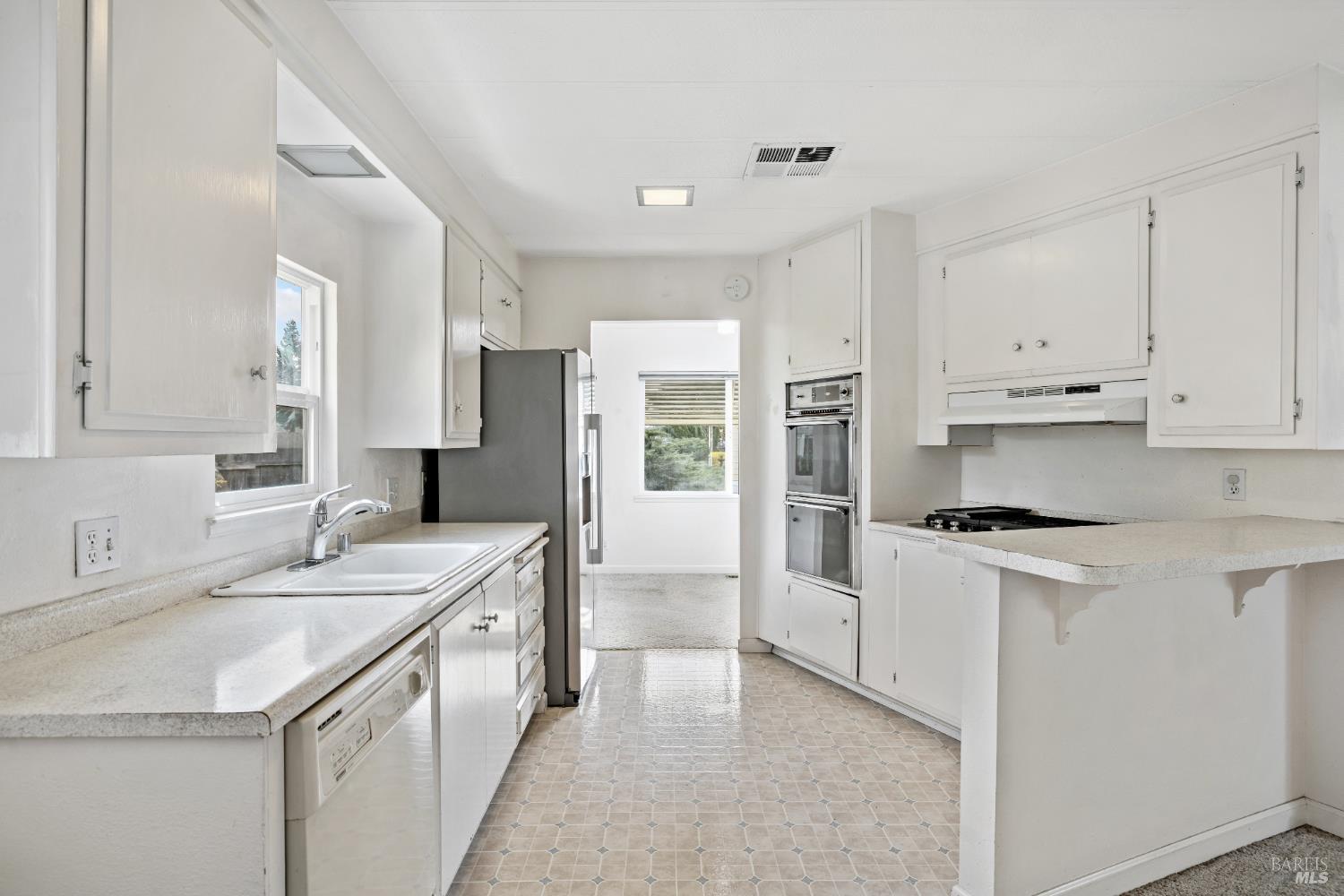 58 Círculo Puerto Rohnert Park, CA 94928 - Photo 11 of 30 a kitchen with stainless steel appliances granite countertop a sink stove and refrigerator