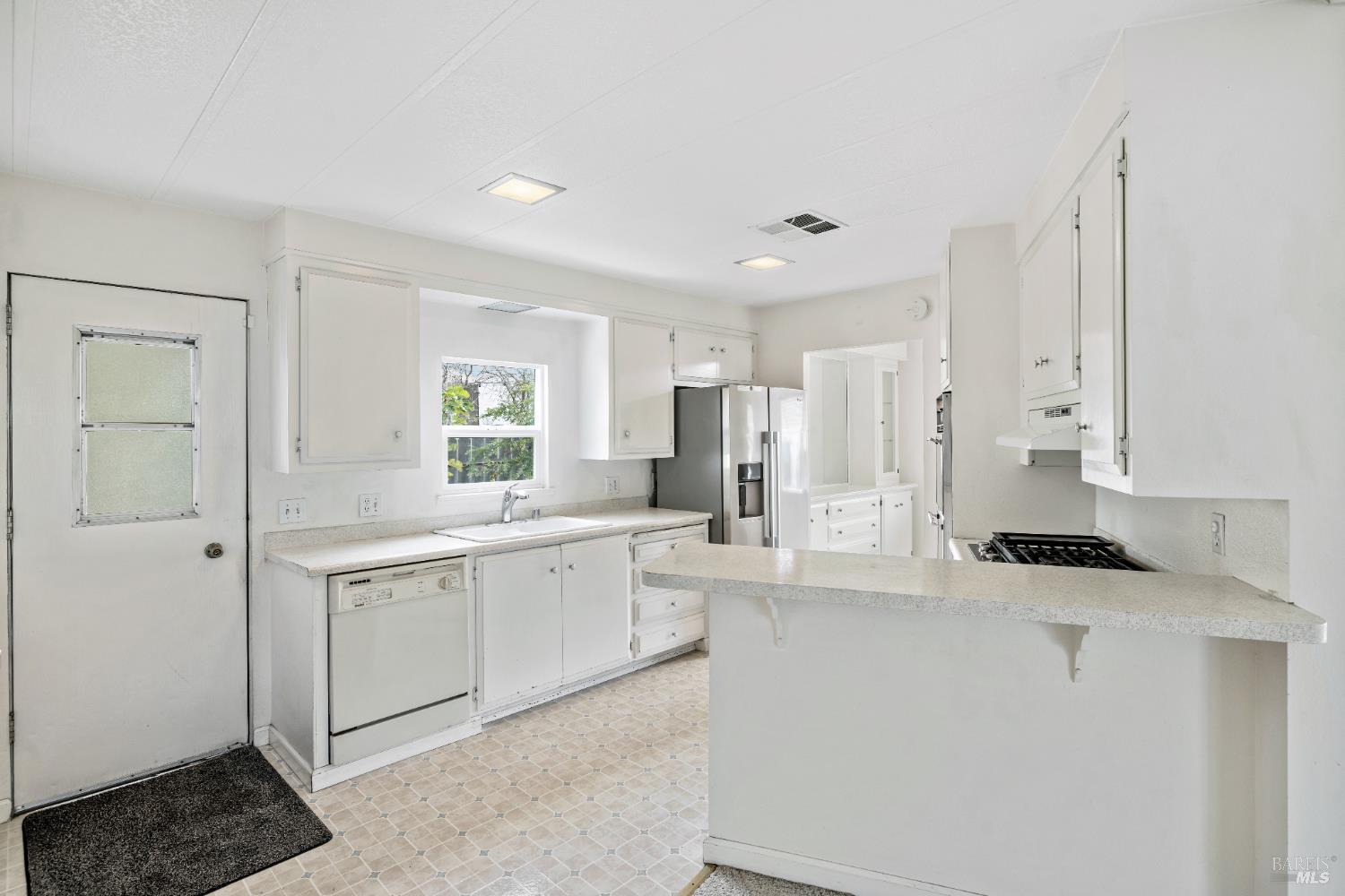 58 Círculo Puerto Rohnert Park, CA 94928 - Photo 10 of 30 a kitchen with white cabinets and refrigerator