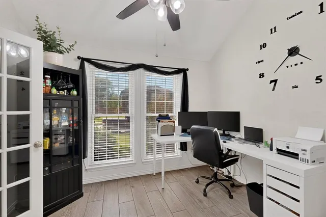 a bedroom with furniture a flat screen tv and a fireplace