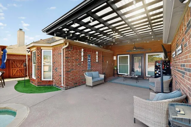 a view of a workspace with furniture and a window