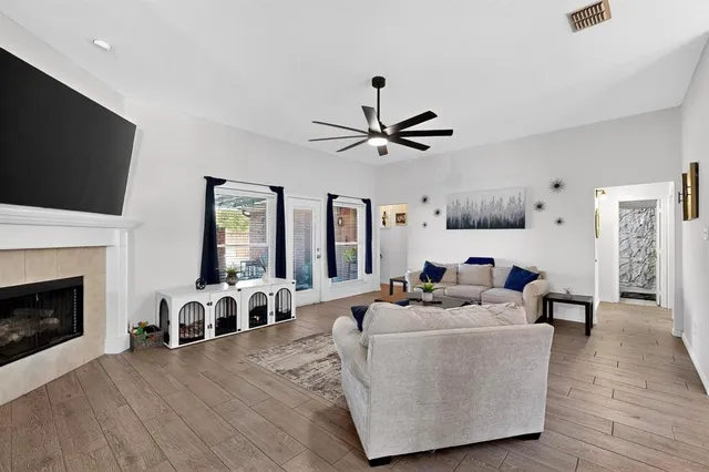 a living room with furniture a fireplace and a flat screen tv
