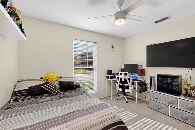 a bedroom with a bed and a large window