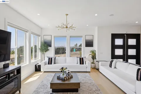 a living room with furniture large window and a flat screen tv
