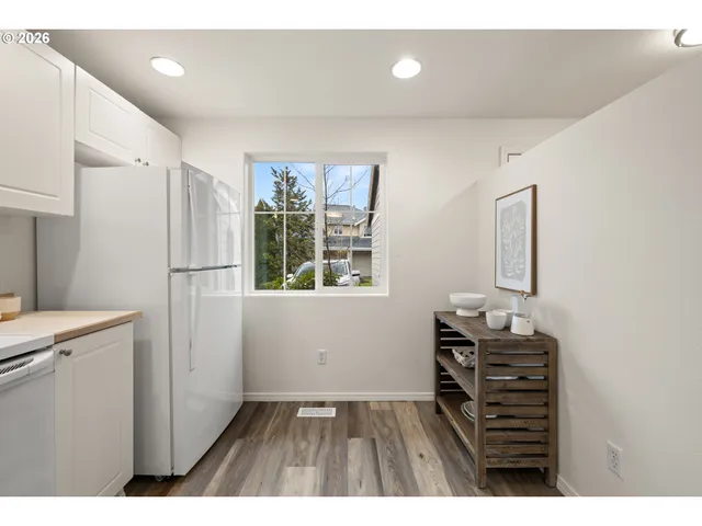 a kitchen with a refrigerator and a sink