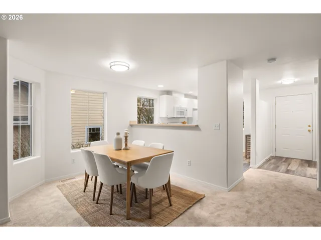 a view of a dining room with furniture and window