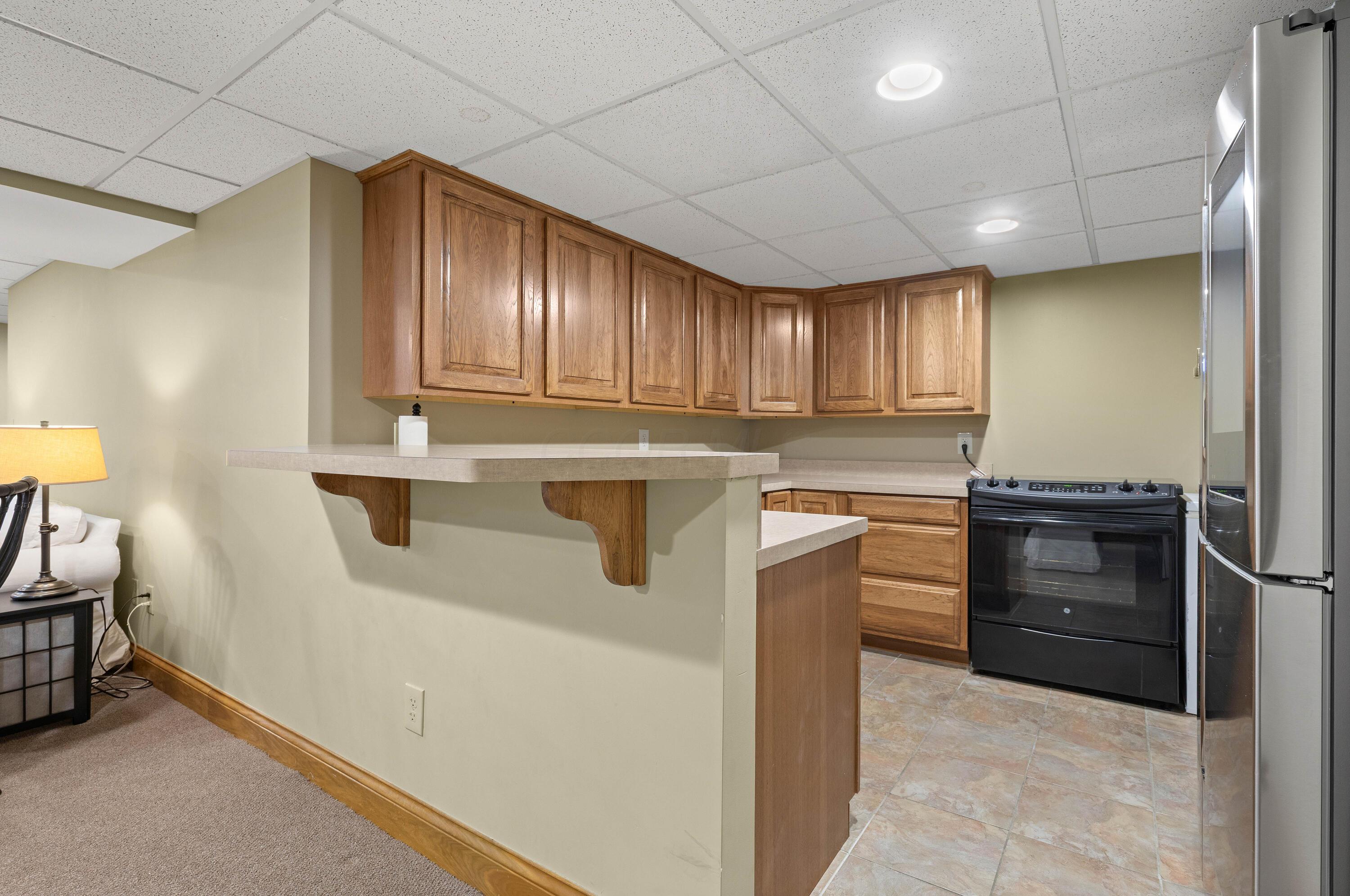1364 Dale Ford Road Delaware, OH 43015 - Photo 76 of 112 • Ceramic tile flooring • Sage painted walls • Cabinets • General Electric® electric range • Samsung® refrigerator • Can lighting