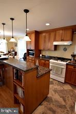 10504 Amherst Avenue Silver Spring, MD 20902 - Photo 4 of 21 a kitchen with stainless steel appliances granite countertop a stove a sink and a refrigerator