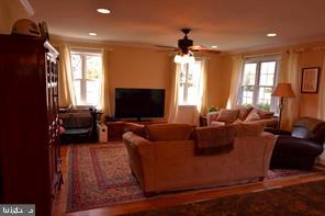 10504 Amherst Avenue Silver Spring, MD 20902 - Photo 7 of 21 a living room with fireplace furniture and a flat screen tv