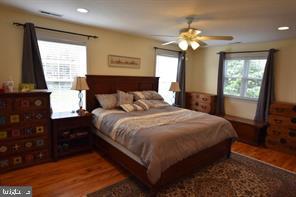 10504 Amherst Avenue Silver Spring, MD 20902 - Photo 9 of 21 a bedroom with a large bed and a flat tv screen on dresser