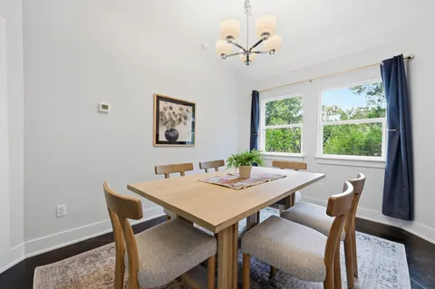 a view of a dining room with a table and chairs