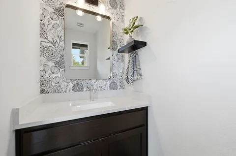 a bathroom with a sink and a mirror