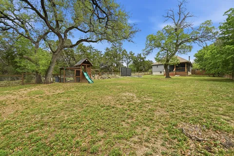 a view of a field with a tree