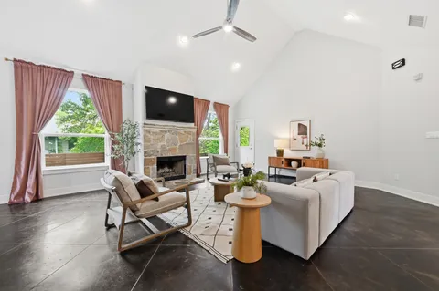 a living room with fireplace furniture and a flat screen tv