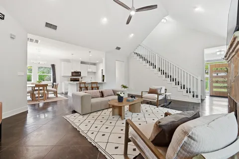 a living room with furniture and a chandelier
