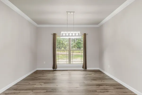 a view of kitchen with kitchen island wooden floor and center island