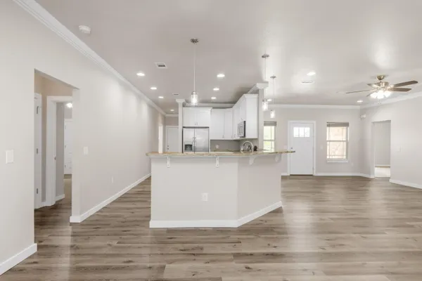 a kitchen with kitchen island a sink stainless steel appliances and window