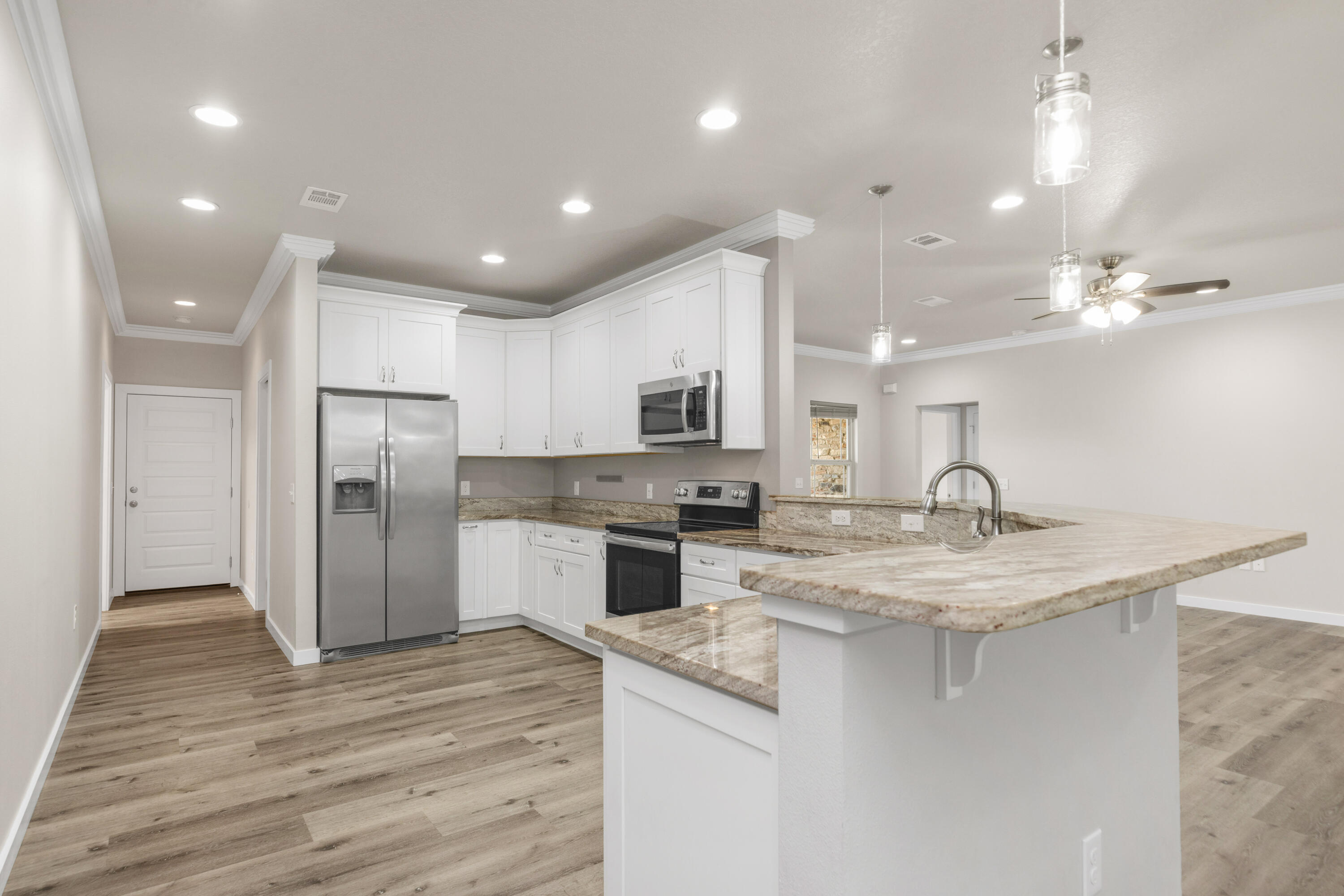 6437 Amanda Court Crestview, FL 32536 - Photo 15 of 48 a kitchen with kitchen island a sink stainless steel appliances and window