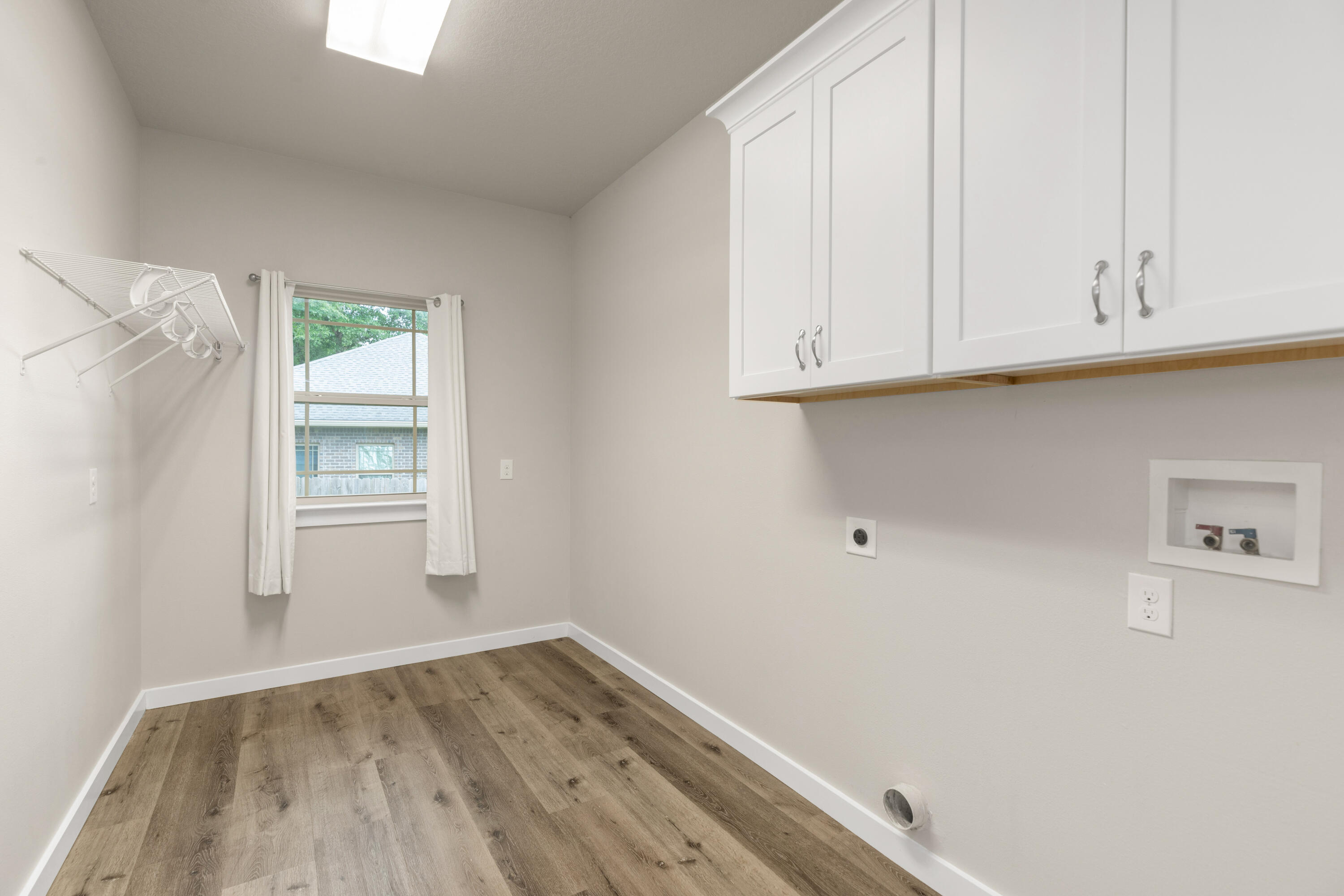 6437 Amanda Court Crestview, FL 32536 - Photo 19 of 48 a view of an empty room with wooden floor and a window