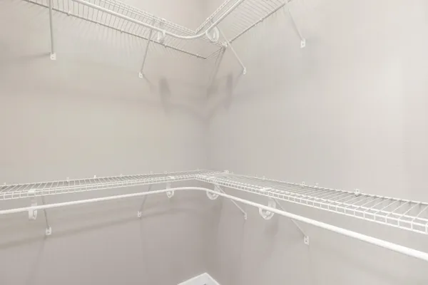 an empty room with a chandelier fan