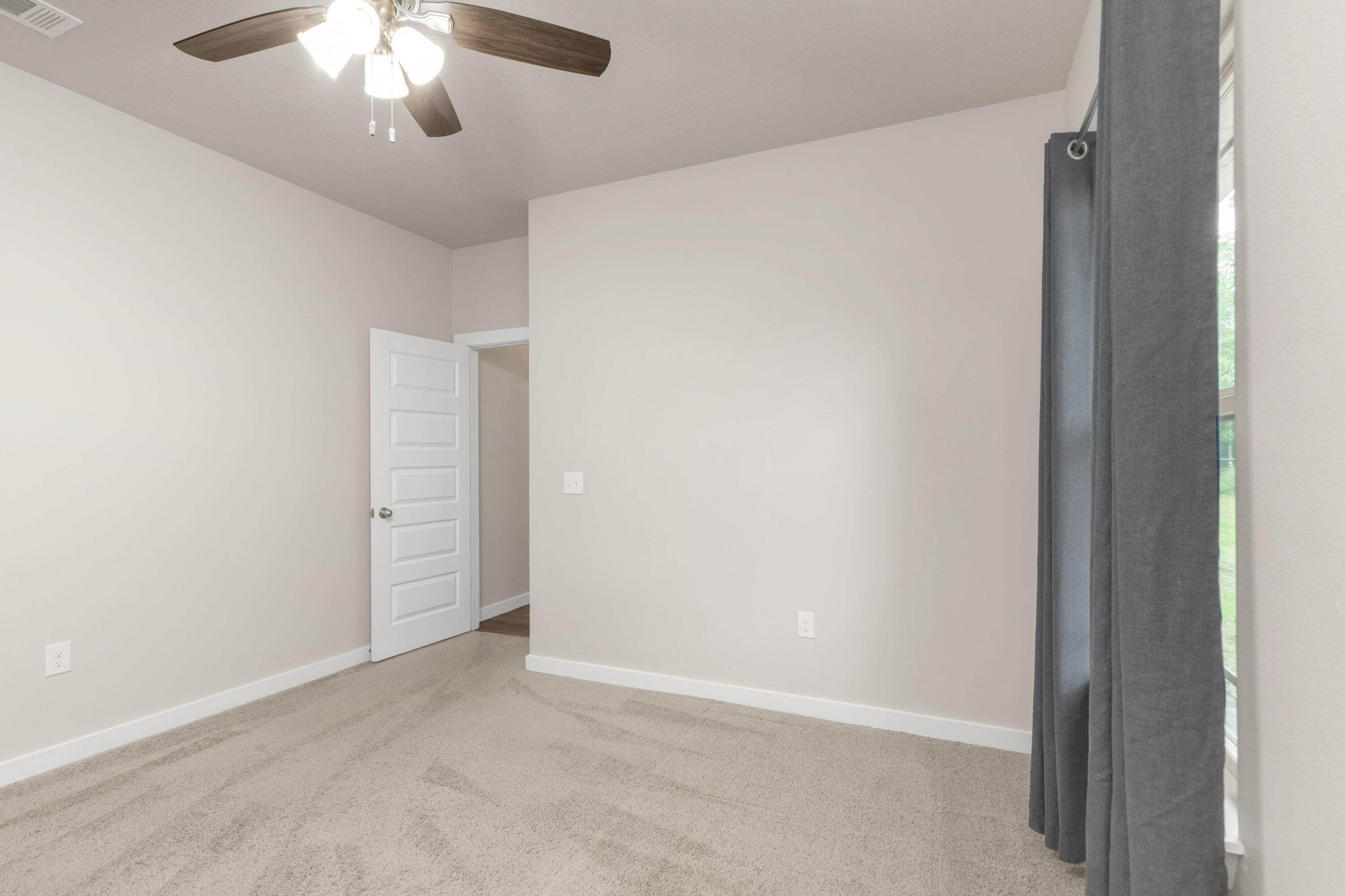 6437 Amanda Court Crestview, FL 32536 - Photo 33 of 48 an empty room with a chandelier fan