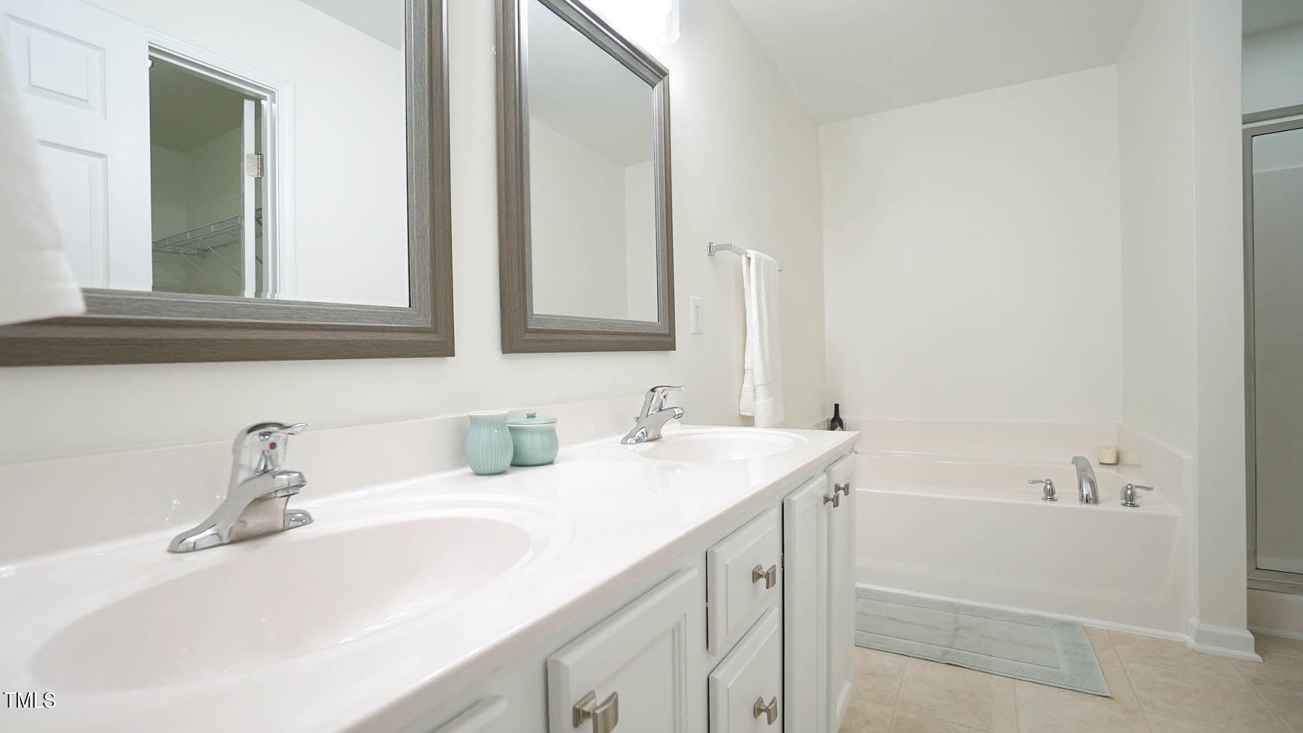 8215 Martello Lane Raleigh, NC 27613 - Photo 12 of 19 Dual vanity with updated mirrors and light fixtures.