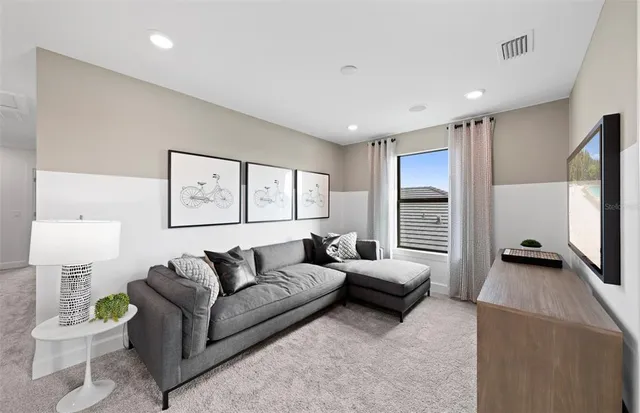 a room with furniture a rug and white walls