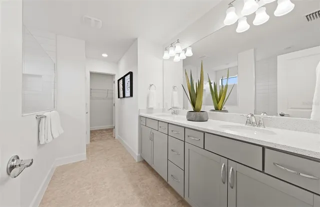 a bathroom with a double vanity sink and a mirror